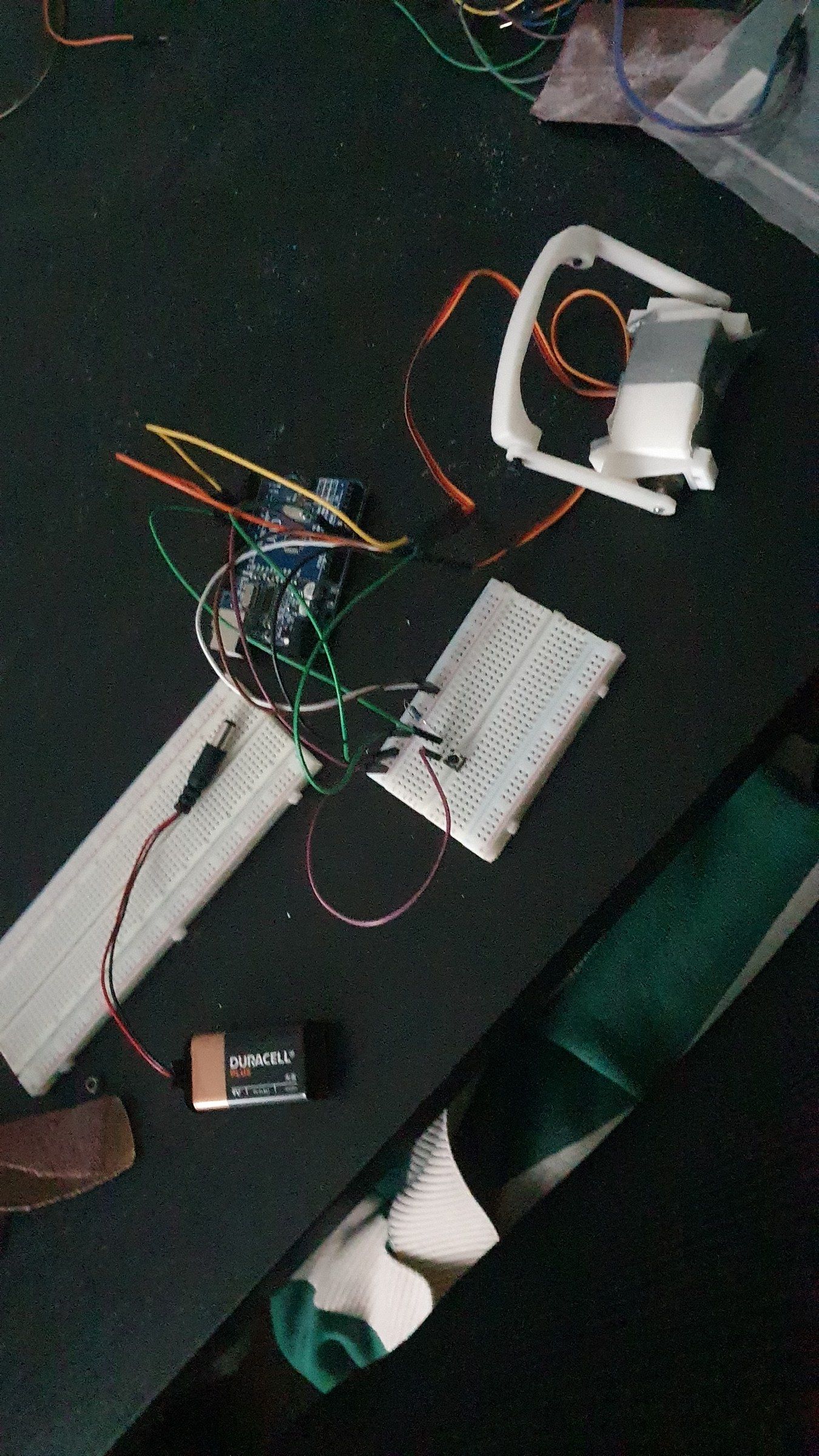 Servo, battery and breadboard wiring for the faceplate mechanism on a desk