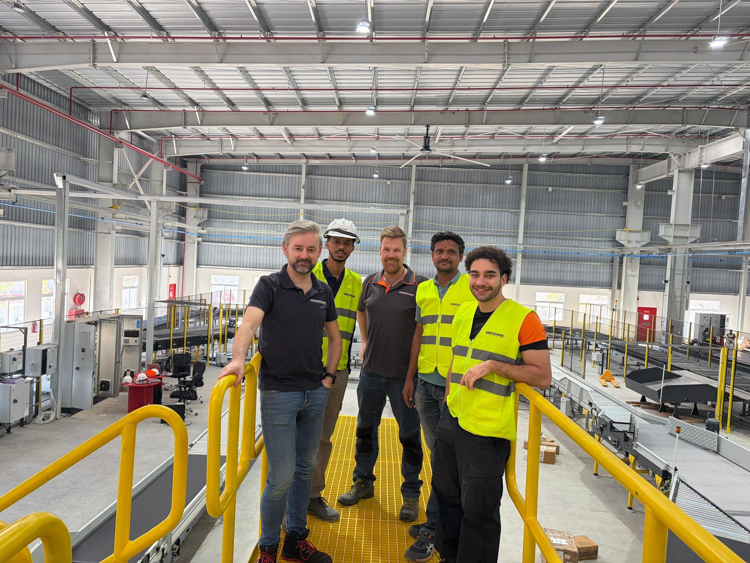 Orhun with the site team on a yellow mezzanine above the sorter