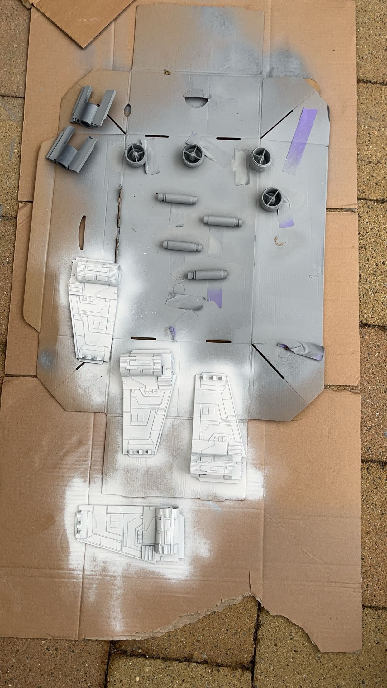 Printed parts laid out on cardboard after spray priming